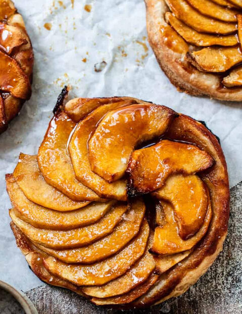 Musical Apple Tartlets Miniature tarts with spiced apples, caramel drizzle, and a touch of cinnamon to make your tastebuds sing.